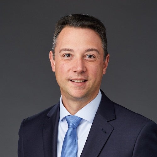  a man in blue suit with blue tie